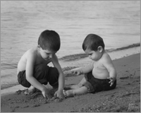 Black and White Child Portrait of two brothers on the beach